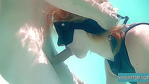 Hot blonde girl is making out with a guy in a swimsuit