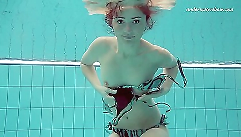 Sexy brunette teen in a sexy outfit is in the shower