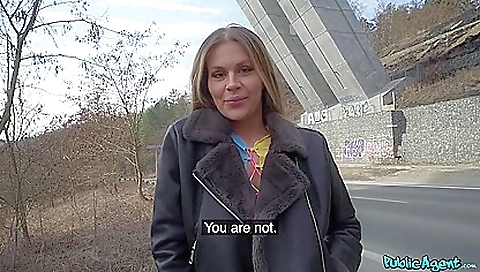 Brunette with big tits rides on a black car on road